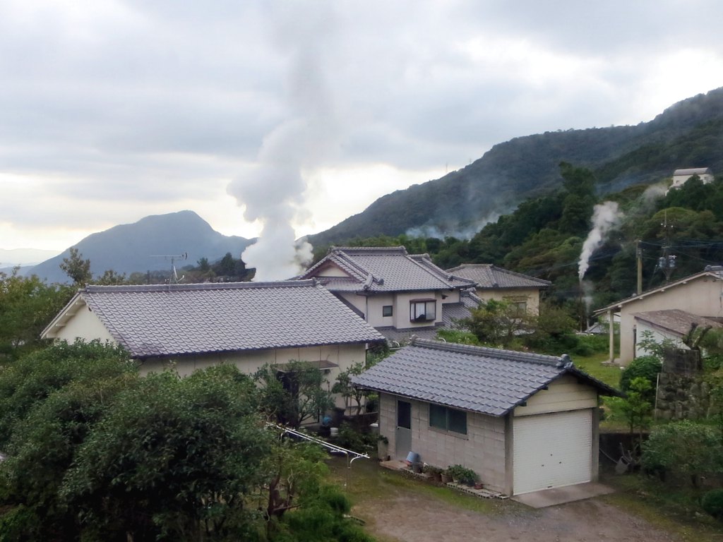 Steam rising among homes in Beppu's hot-spring landscape
