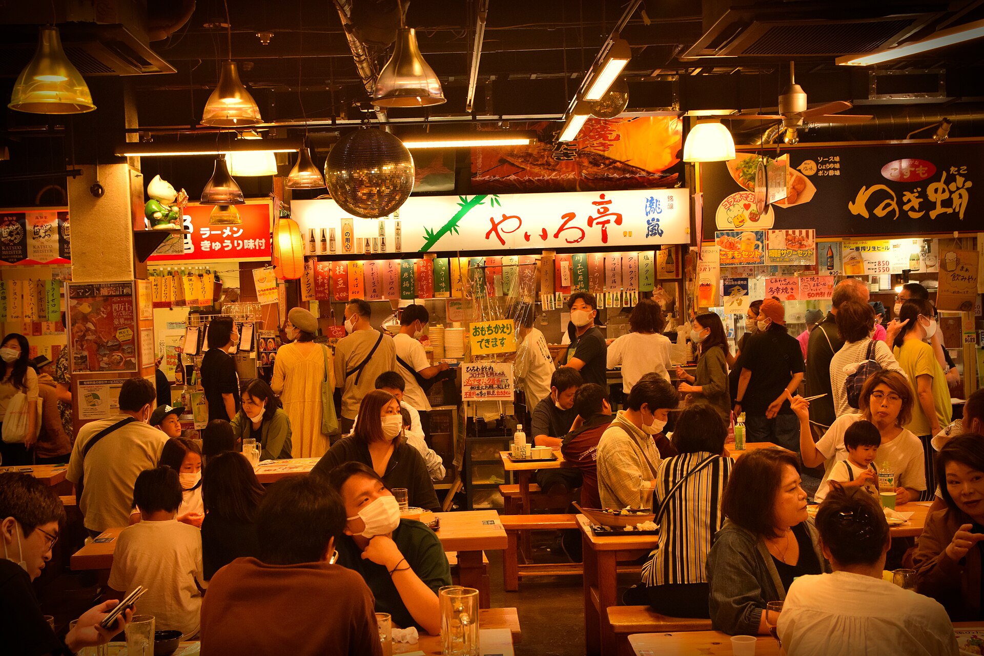 Communal tables and food stalls inside Hirome Market, Kochi